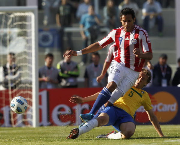 Paraguay's Roque Santa Cruz (9) loses the ball to Brazil's Lucas Leiva during their match in the first round of the Copa America soccer tournament in Cordoba, July 9, 2011. Brazil draws Paraguay 2-2 in Copa America