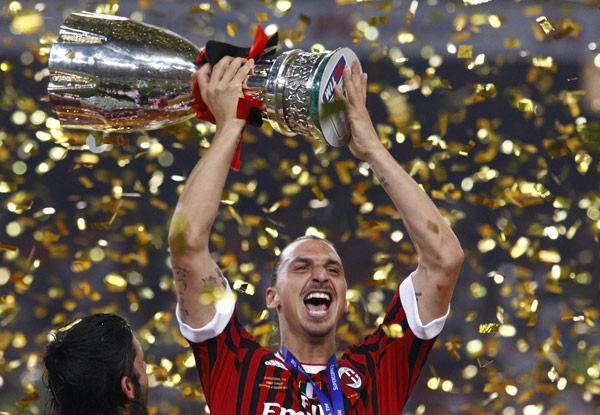 AC Milan's Zlatan Ibrahimovic celebrates with the trophy after winning the Italian Super Cup soccer match against Inter Milan at the National Olympic Stadium, also known as the Bird's Nest, in Beijing, August 6, 2011. Milan edge out Inter in Super Cup