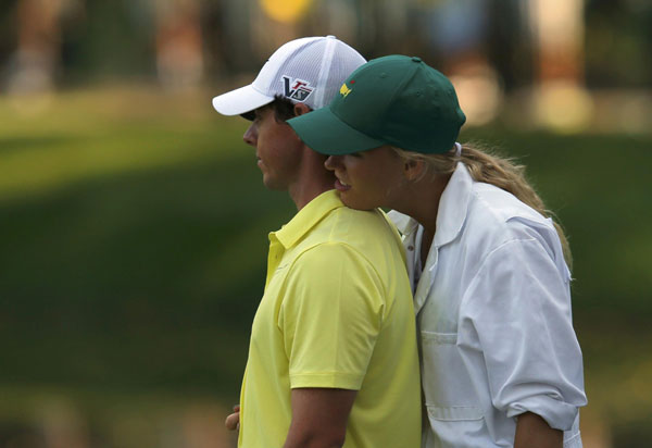 Rory McIlroy of Northern Ireland stands with his girlfriend, tennis player Caroline Wozniacki of Denmark on the ninth green during the annual Masters Par 3 Contest at the Augusta National Golf Club in Augusta, Georgia, April 10, 2013. Maturing McIlroy calls talk of rivalry with Woods premature