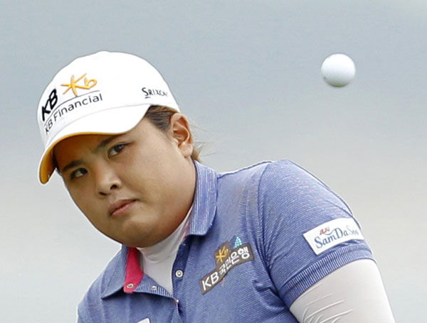 Inbee Park of South Korea chips onto the 11th green during the final round of the 2013 US Women's Open golf championship at the Sebonack Golf Club in Southampton, New York, June 30, 2013. South Korean Park wins third consecutive major