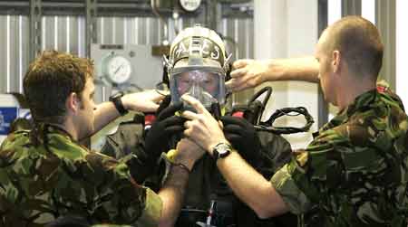 Britain&apos;s Prince Harry (C) checks his equipment during his visit to the Royal Navy&apos;s fleet diving squadron at Horsea Island in Portsmouth, southern England, Oct. 31, 2007. It was Prince Harry&apos;s first official visit since becoming Commodore-in-Chief of small ships and diving