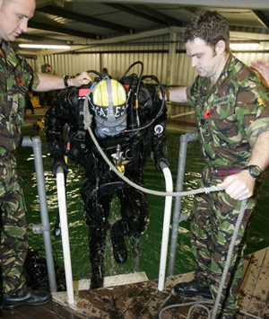 Britain&apos;s Prince Harry (C) is helped out the water after carrying out some underwater engineering during his visit to the Royal Navy&apos;s fleet diving squadron at Horsea Island in Portsmouth, southern England, Oct. 31, 2007. It was Prince Harry&apos;s first official visit since becoming Commodore-in-Chief of small ships and diving.