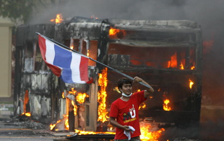Thai troops surround protestors after 2 killed in clash