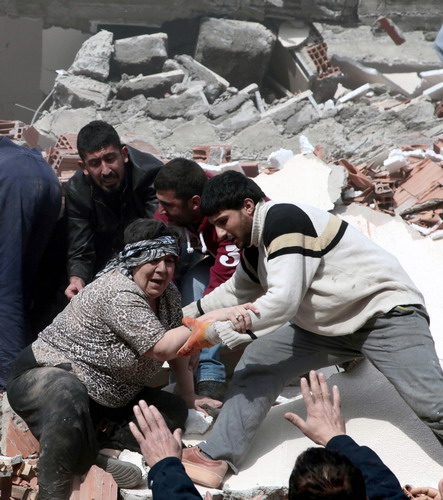 People rescue two women trapped under debris in Van, eastern Turkey, on Sunday. Huge earthquake hits southeast Turkey
