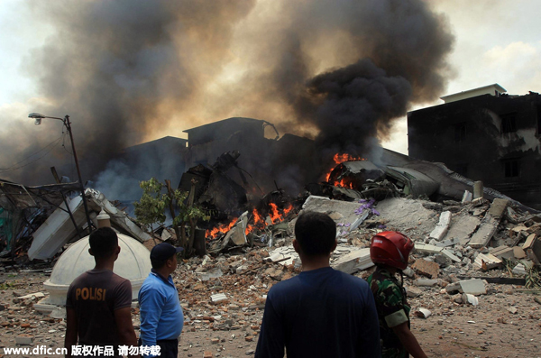 Military plane crashes into residential area in Indonesia